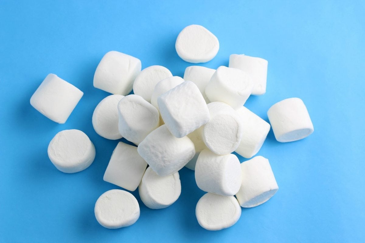 pile of jumbo marshmallows on blue background 