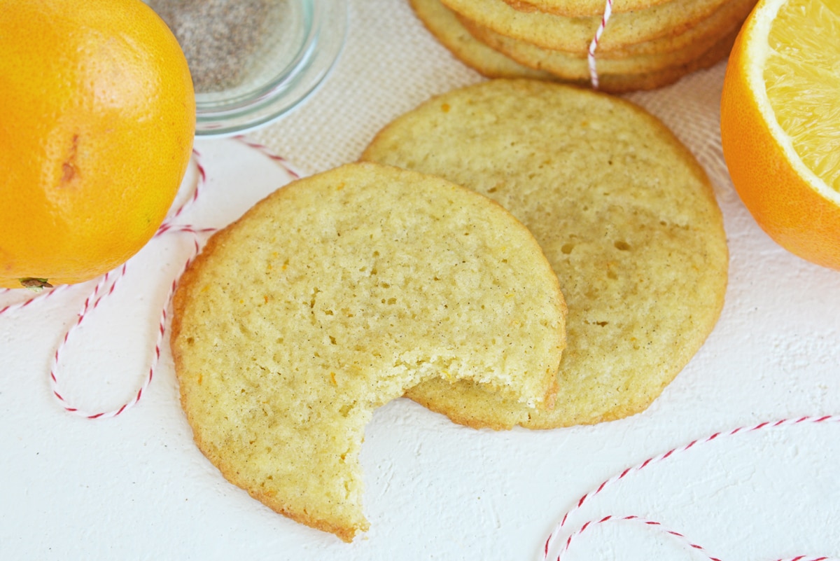 cookies with a bite taken out of it and fresh oranges 