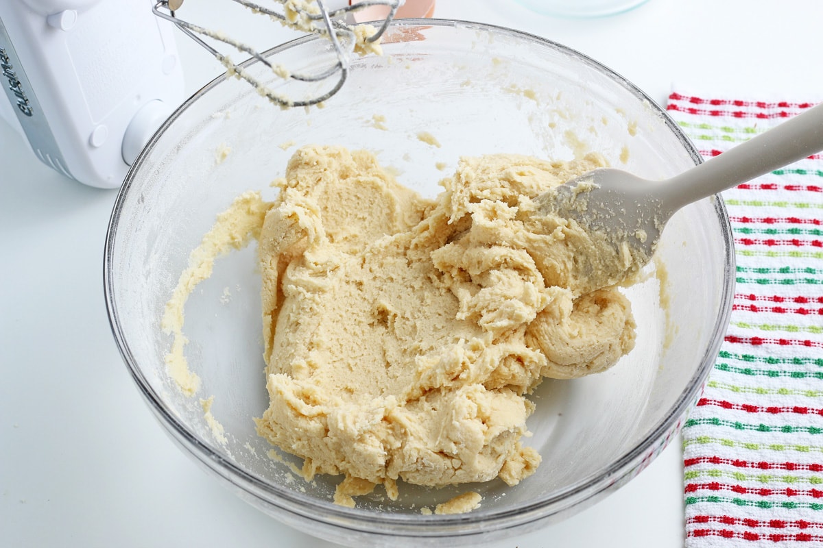 sugar cookie dough in a clear glass mixing bowl  