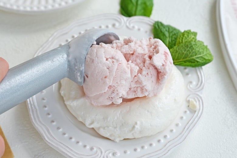 scoop of strawberry ice cream on meringue 
