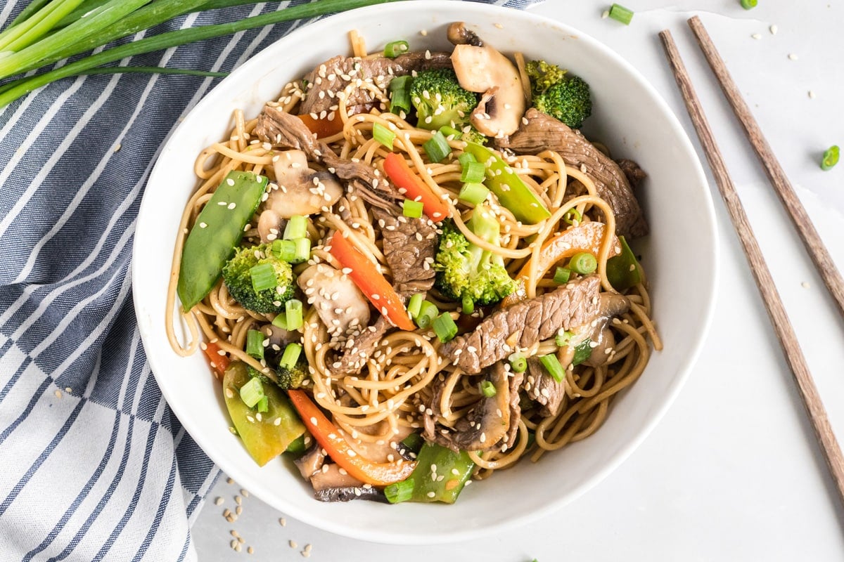 overhead of lo mein in a white bowl