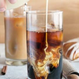 cream poured into iced coffee