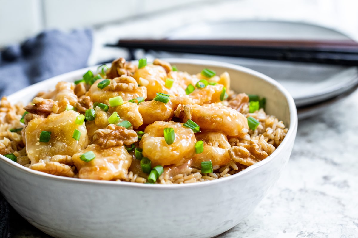 angle view of honey walnut shrimp with scallions 