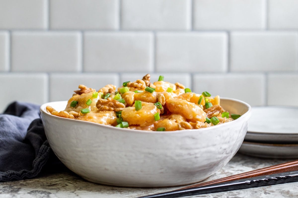 side view of honey walnut shrimp with chopsticks 