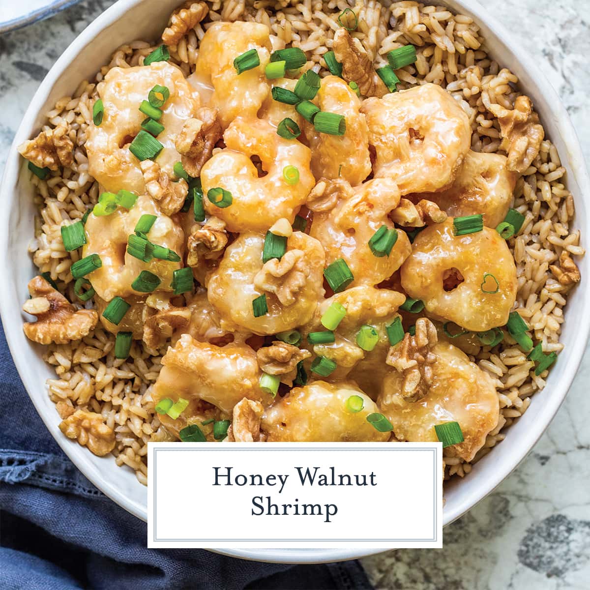 overhead of honey walnut shrimp over brown rice with scallions