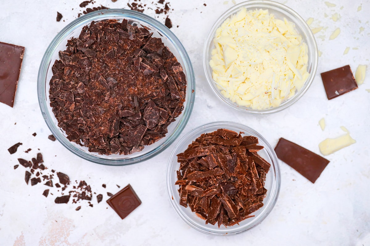 three bowls of chopped chocolate 