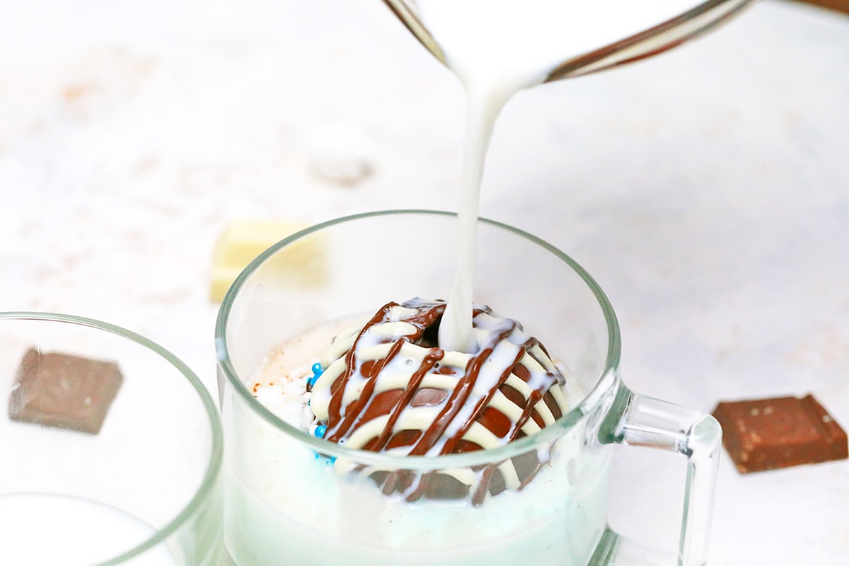 milk pouring over a hot cocoa bomb