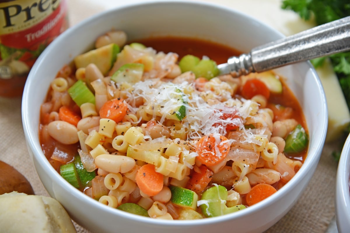 angle of minestrone soup in a white bowl 