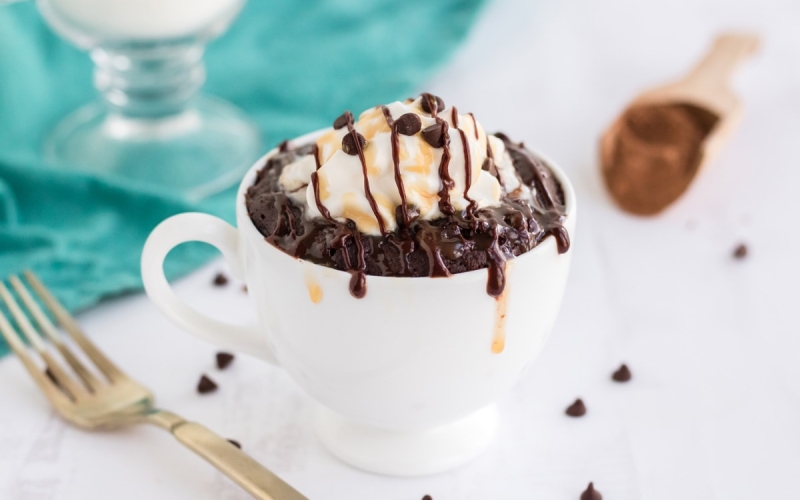 angle of brownie in a mug with teal background