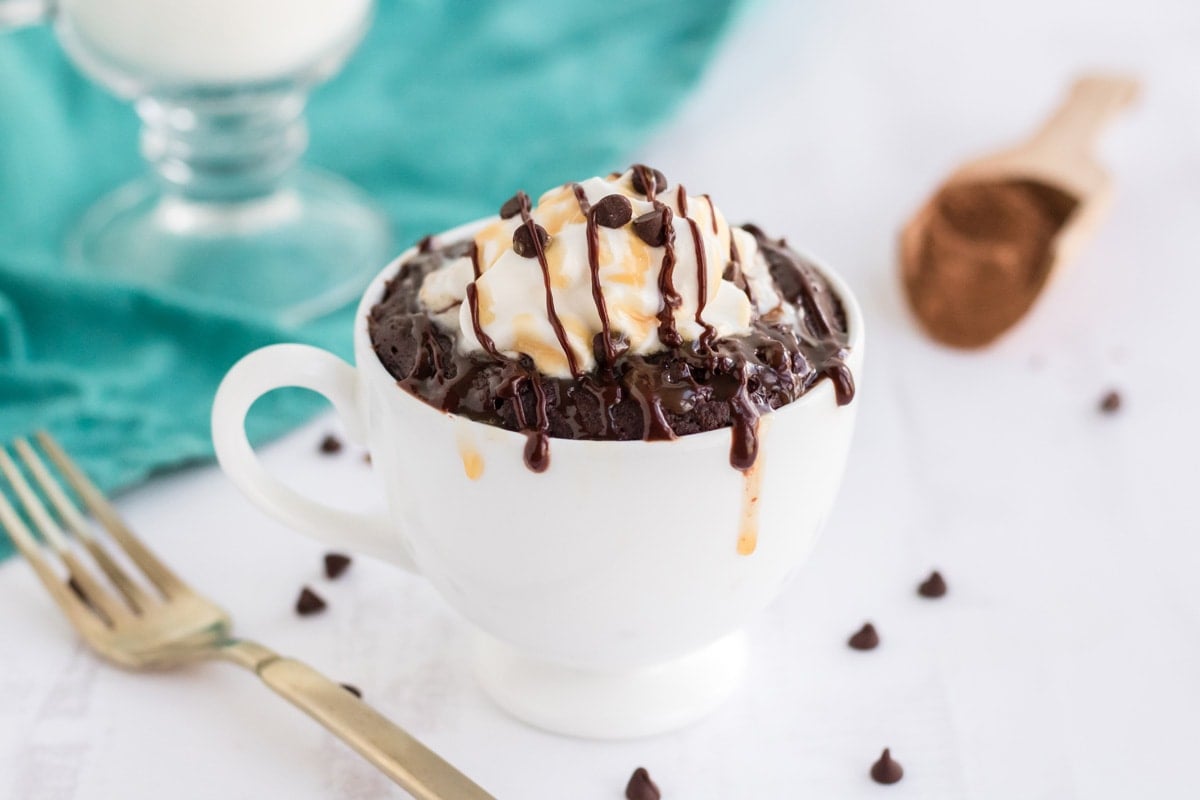 angle of brownie in a mug with teal background