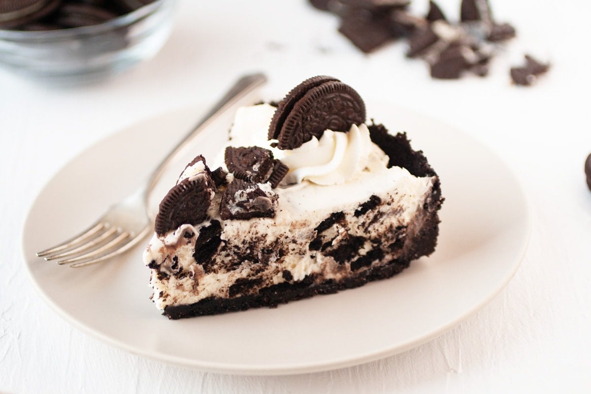 slice of oreo cheesecake on a white serving plate 