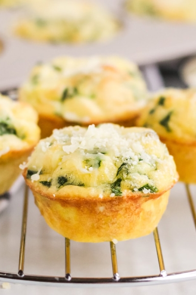 close up of quiche florentine muffins on a cooling rack