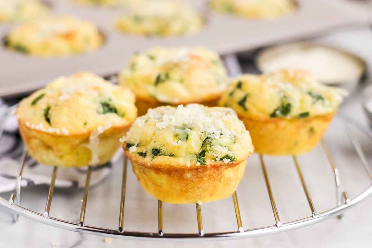 close up of quiche florentine muffins on a cooling rack