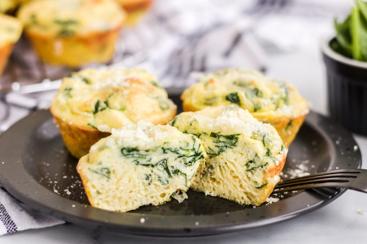 egg muffin on black plate cut in half 