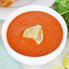 close up of ranchero sauce with limes
