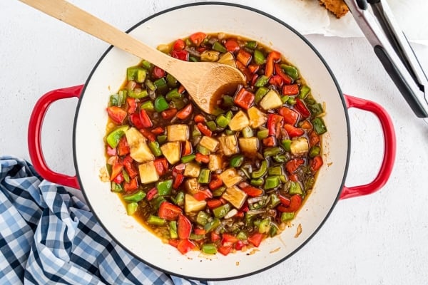 cooking vegetables and sauce in a skillet