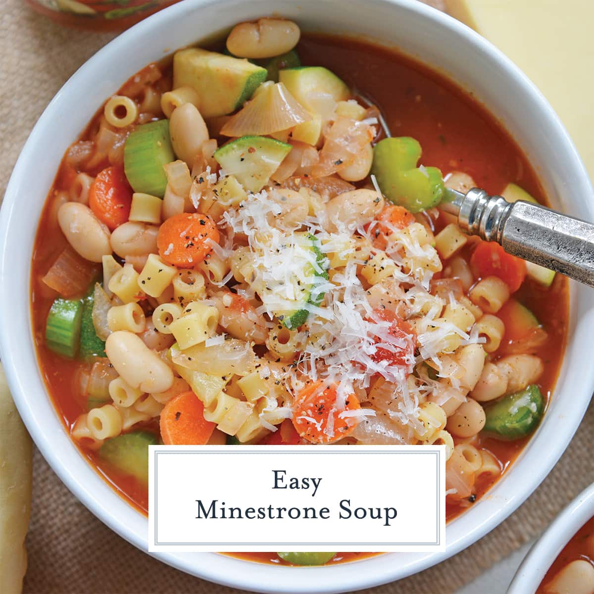 overhead of minestrone soup in a white bowl