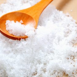 salt in a wooden testing spoon