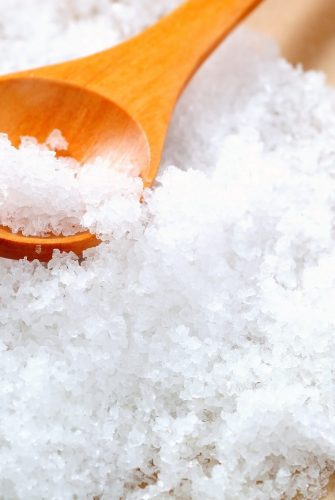 salt in a wooden testing spoon