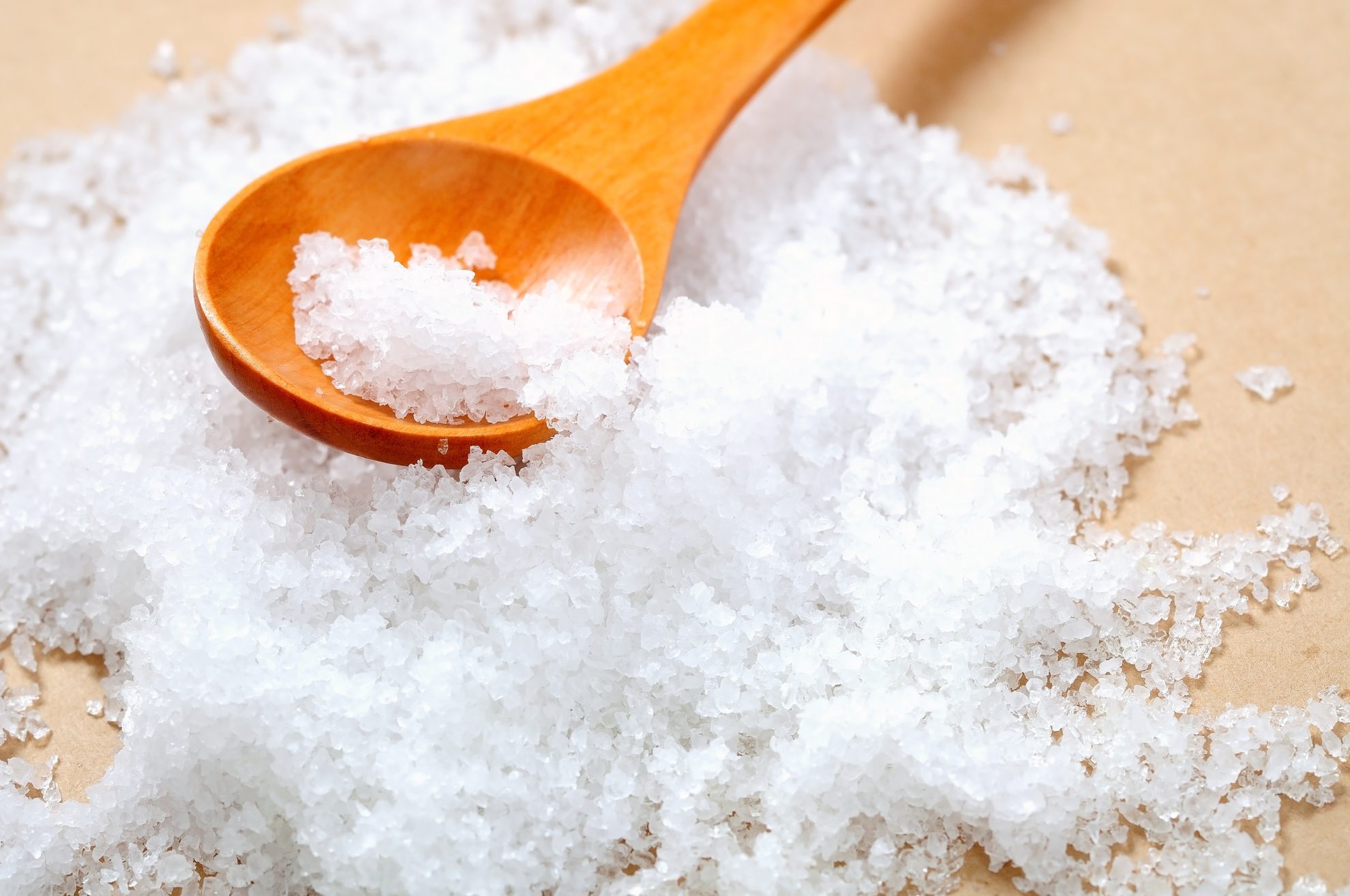 salt in a wooden testing spoon