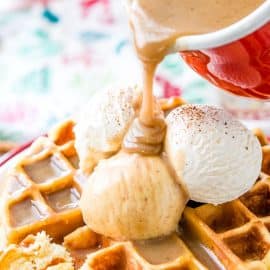 vanilla syrup pouring over eggnog waffles