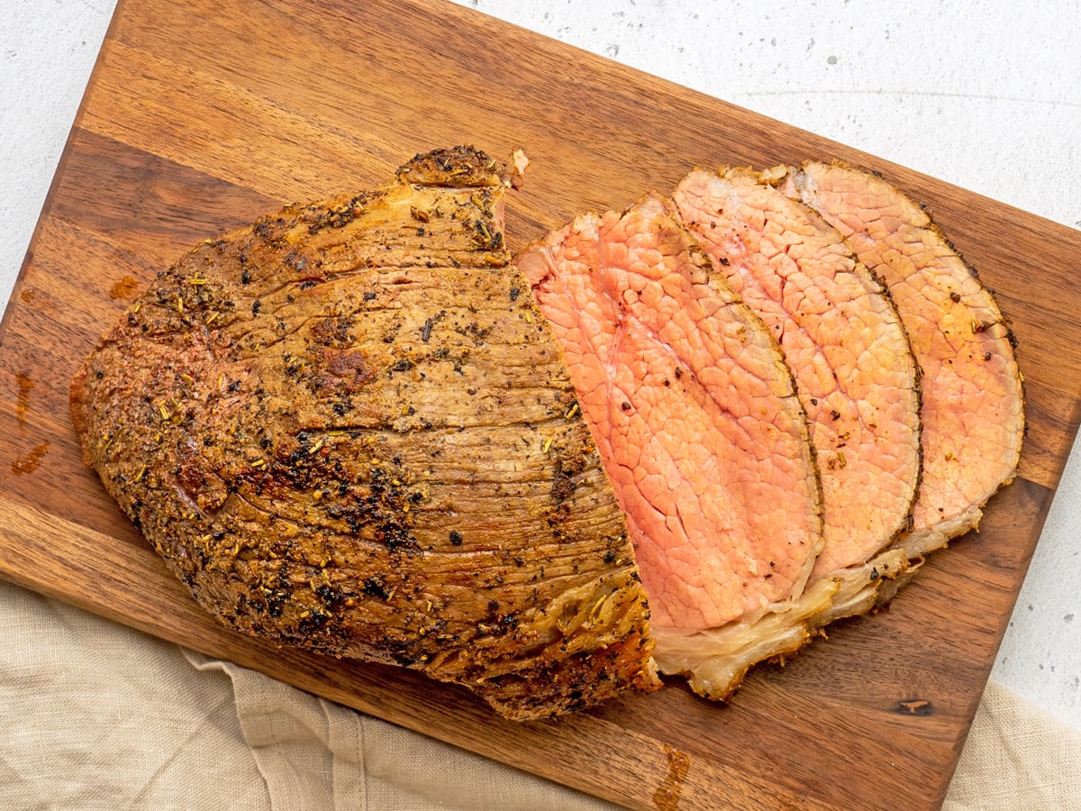 sliced eye of round roast on a cutting board 