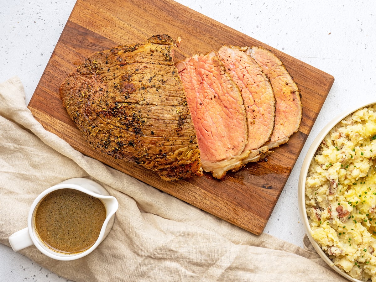 overhead sliced roast beef on a cutting board 