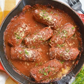 overhead of beef braciole in a skillet