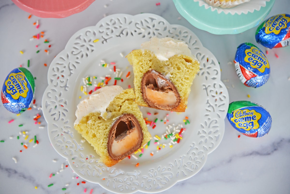 overhead shot of cadbury egg cupcake cut in half on plate