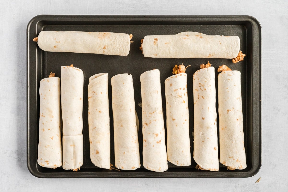 chicken taquito rolls on a baking sheet 