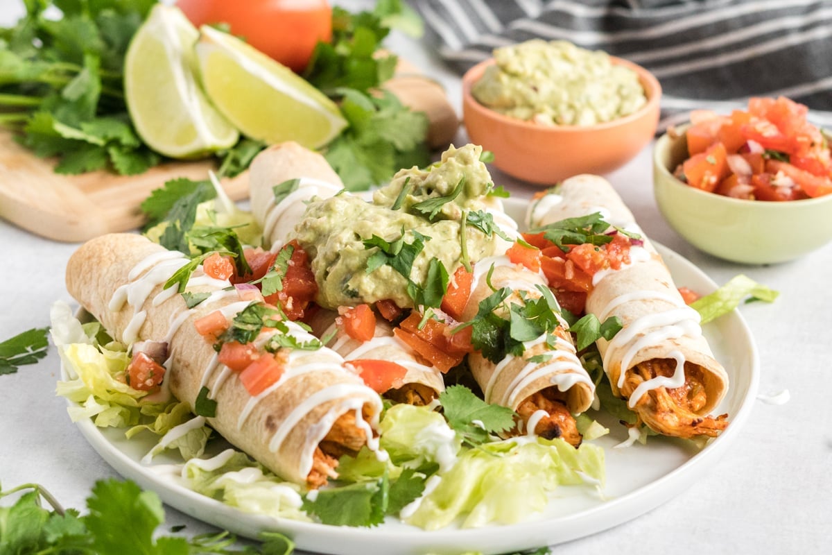 dressed chicken taquitos on a plate 