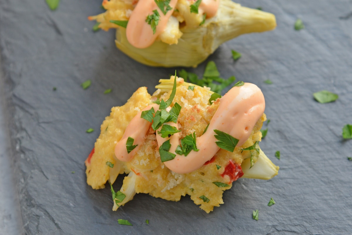 overhead shot of two crab dip stuffed artichoke hearts