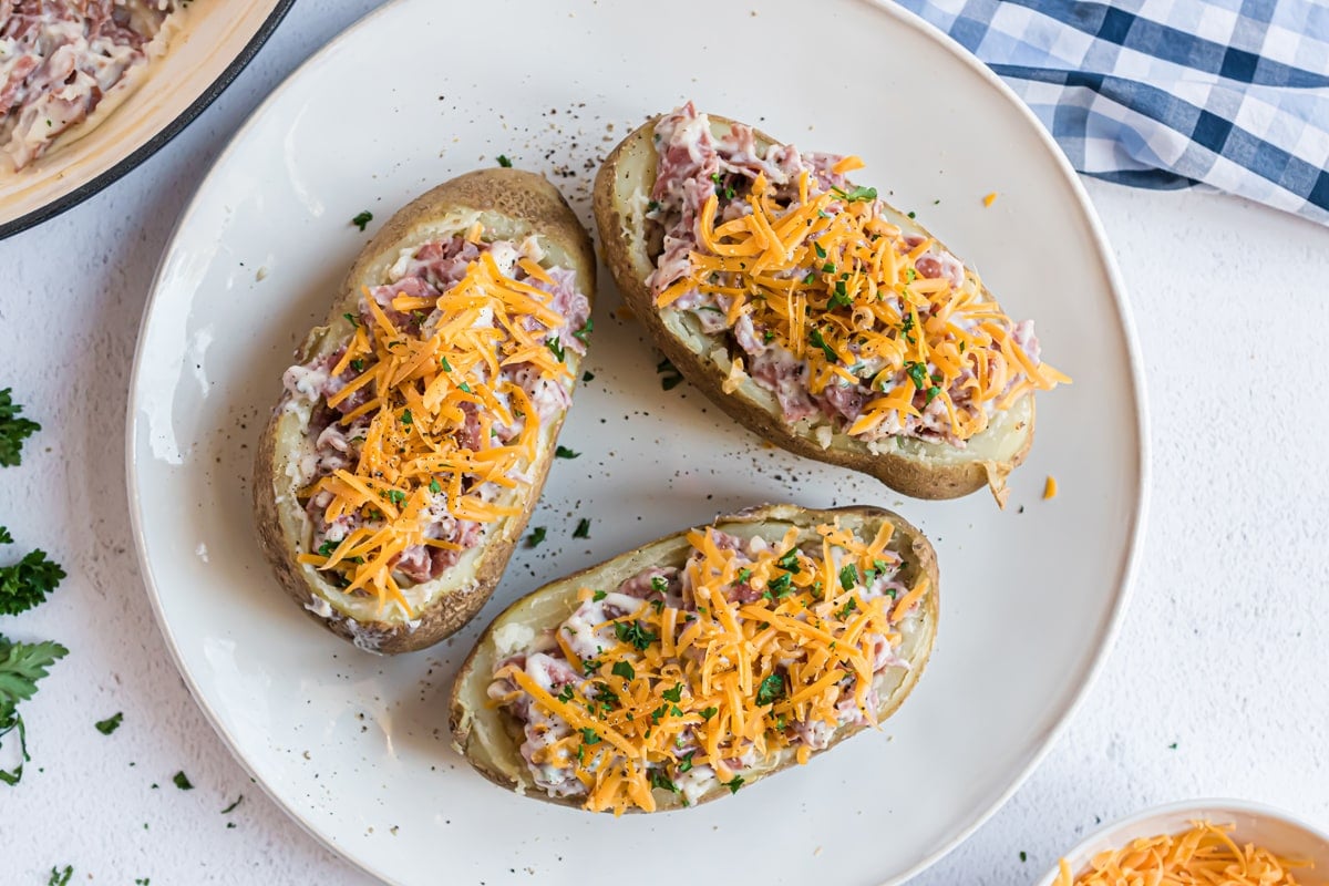 overhead of three creamed chipped beef potatoes topped with cheddar cheese 
