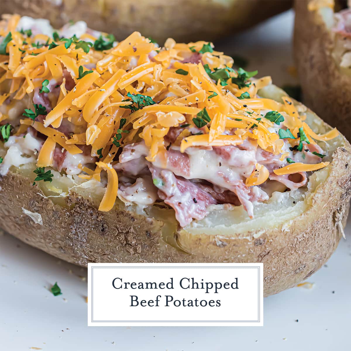 close up of creamed chipped beef potato topped with shredded cheese 