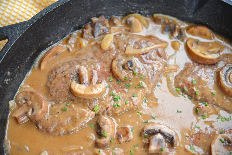 close up of cube steak in a skillet