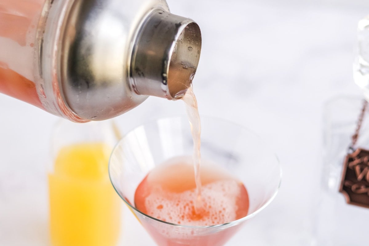 pouring martini out of a shaker 