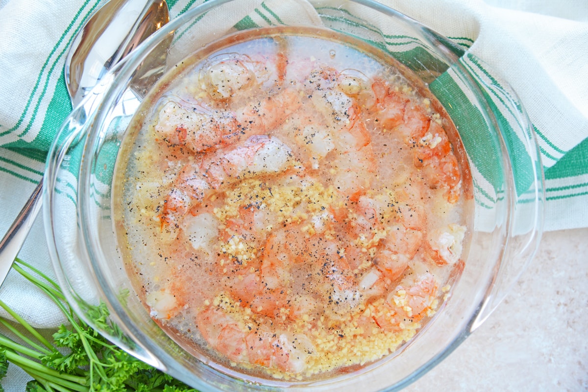 overhead shot of shrimp marinating in bowl