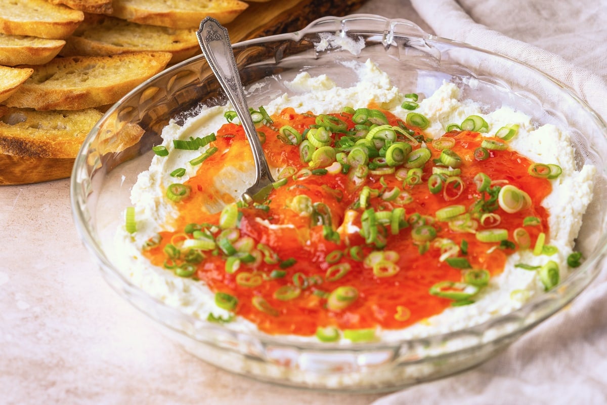 angle view of spoon in goat cheese dip 