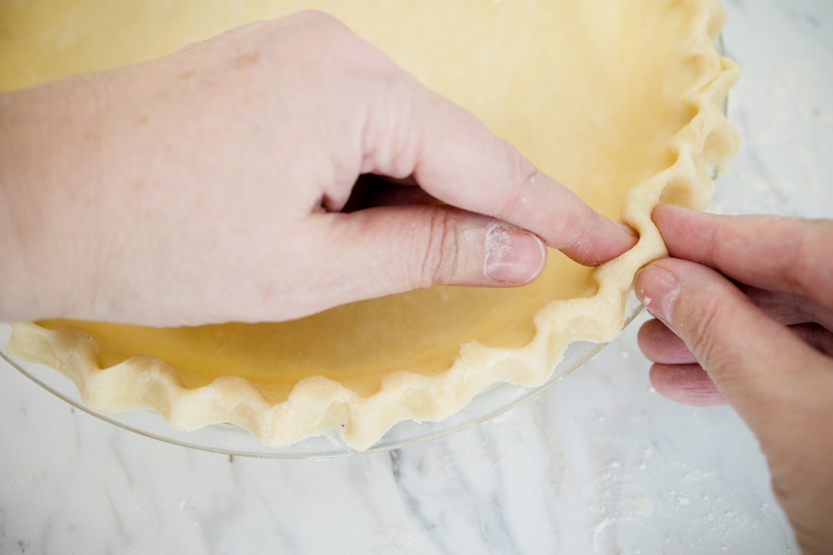 pinching together pie crust edges