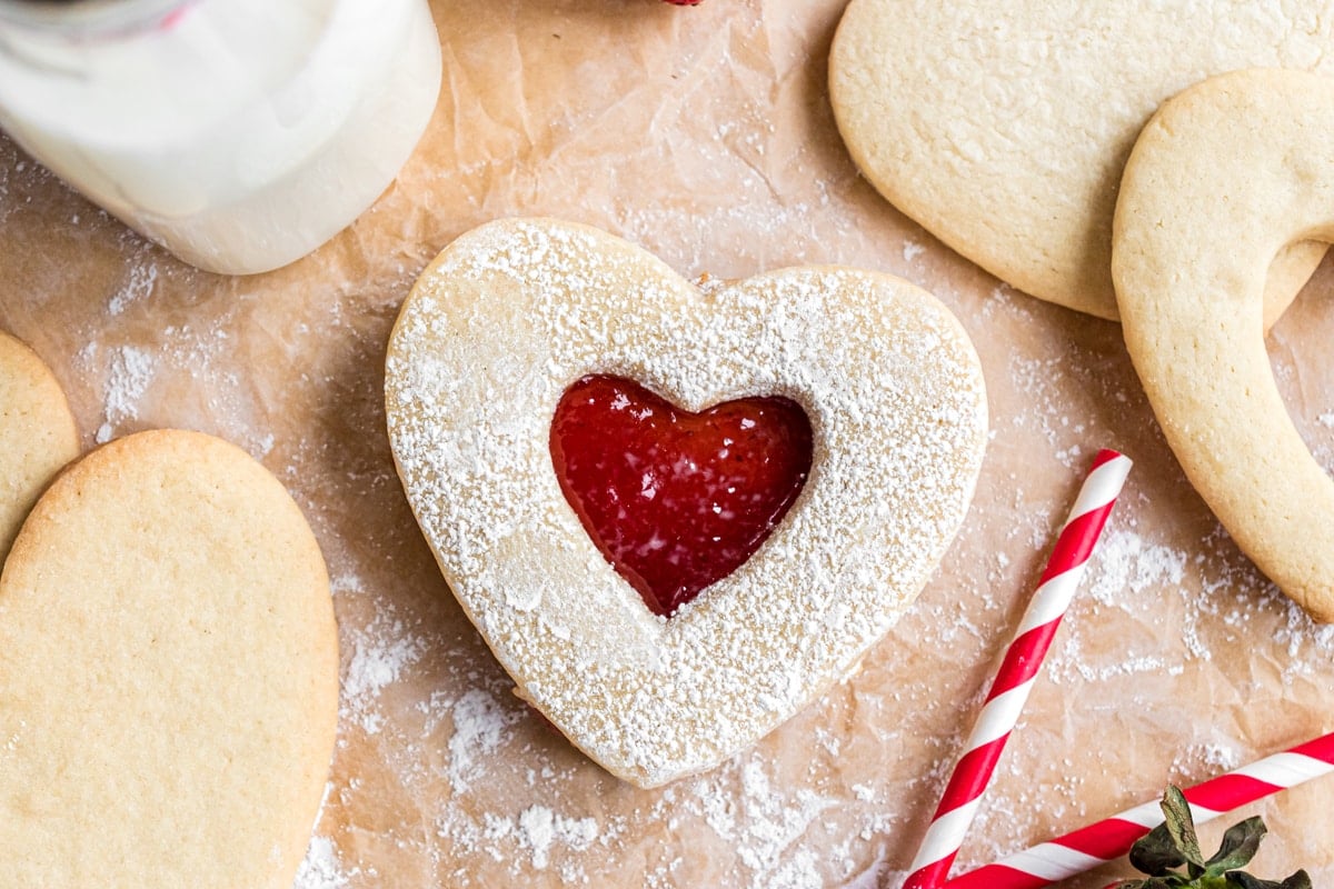 overhead of jammie dodger cookie with red and white straws 