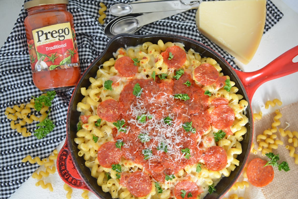 overhead of pizza mac and cheese with black and white checkered linen  