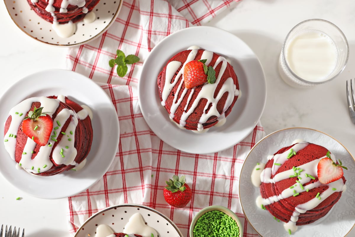 overhead of plates of red velvet pancakes 