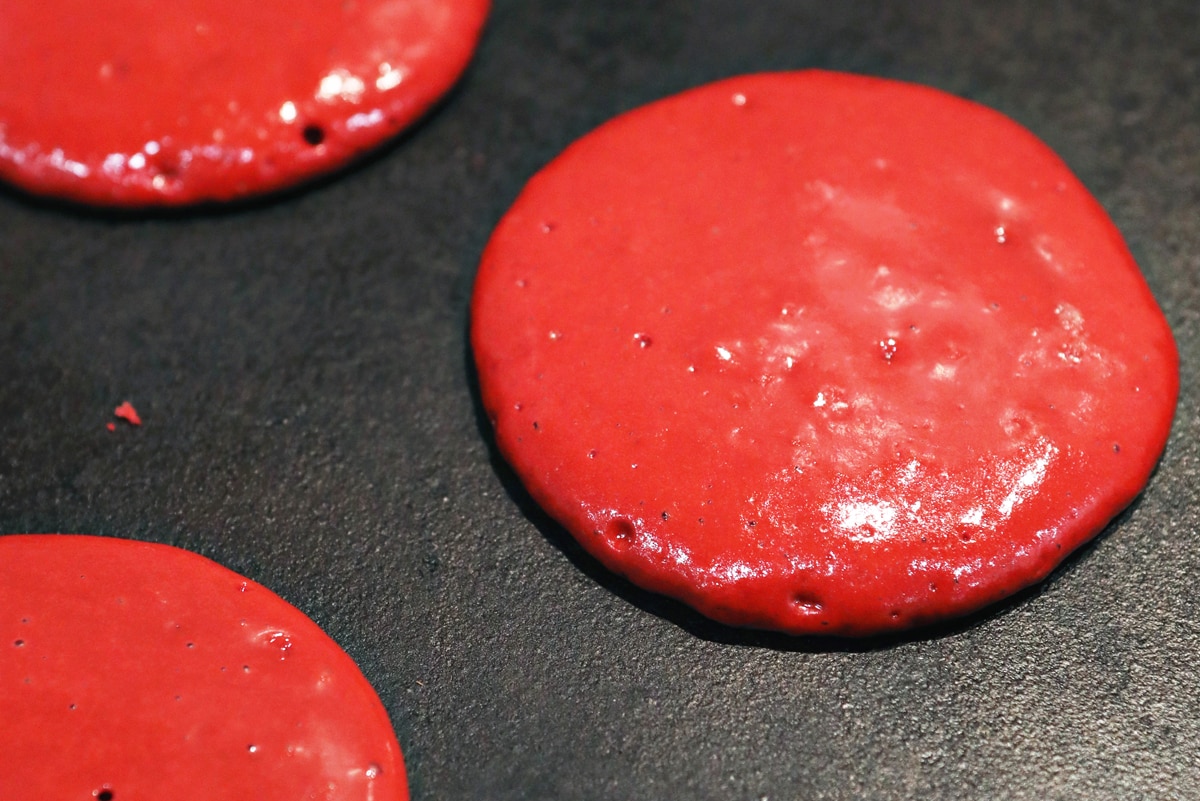 red velvet pancakes on a griddle  