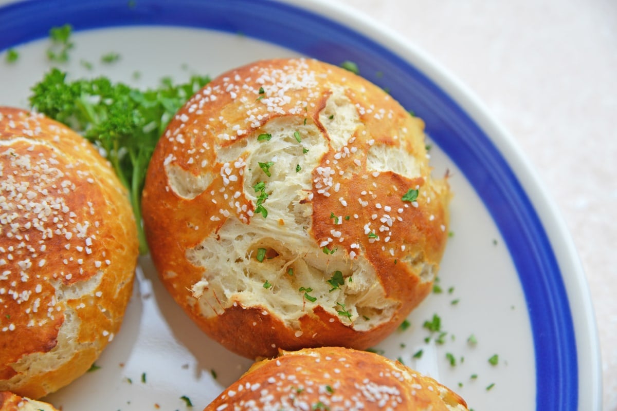 close up overhead shot of plate of pulled pork stuffed pretzel rolls