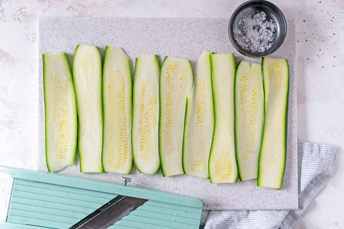 zucchini slices on a cutting board 