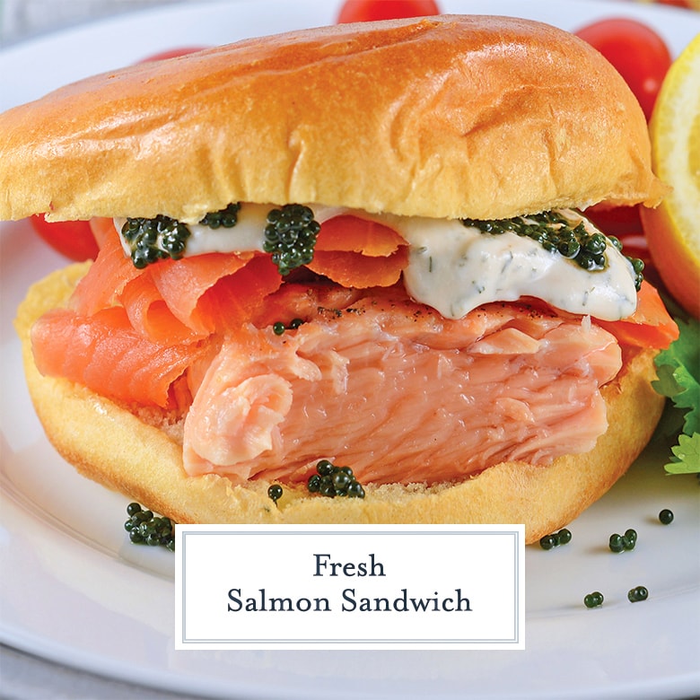 side view of salmon sandwich with fresh salmon, smoked and dilled sour cream on brioche bun 