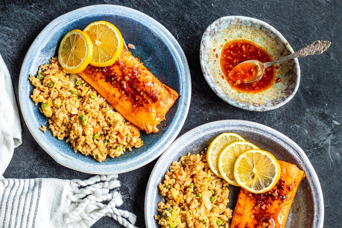 two blue dishes with air fryer salmon and fried rice  