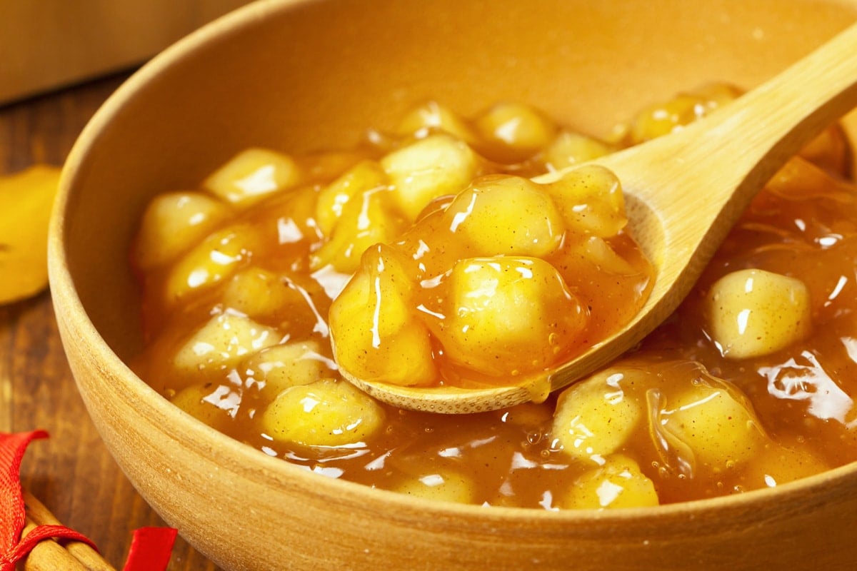 close up spoon of apple pie filling