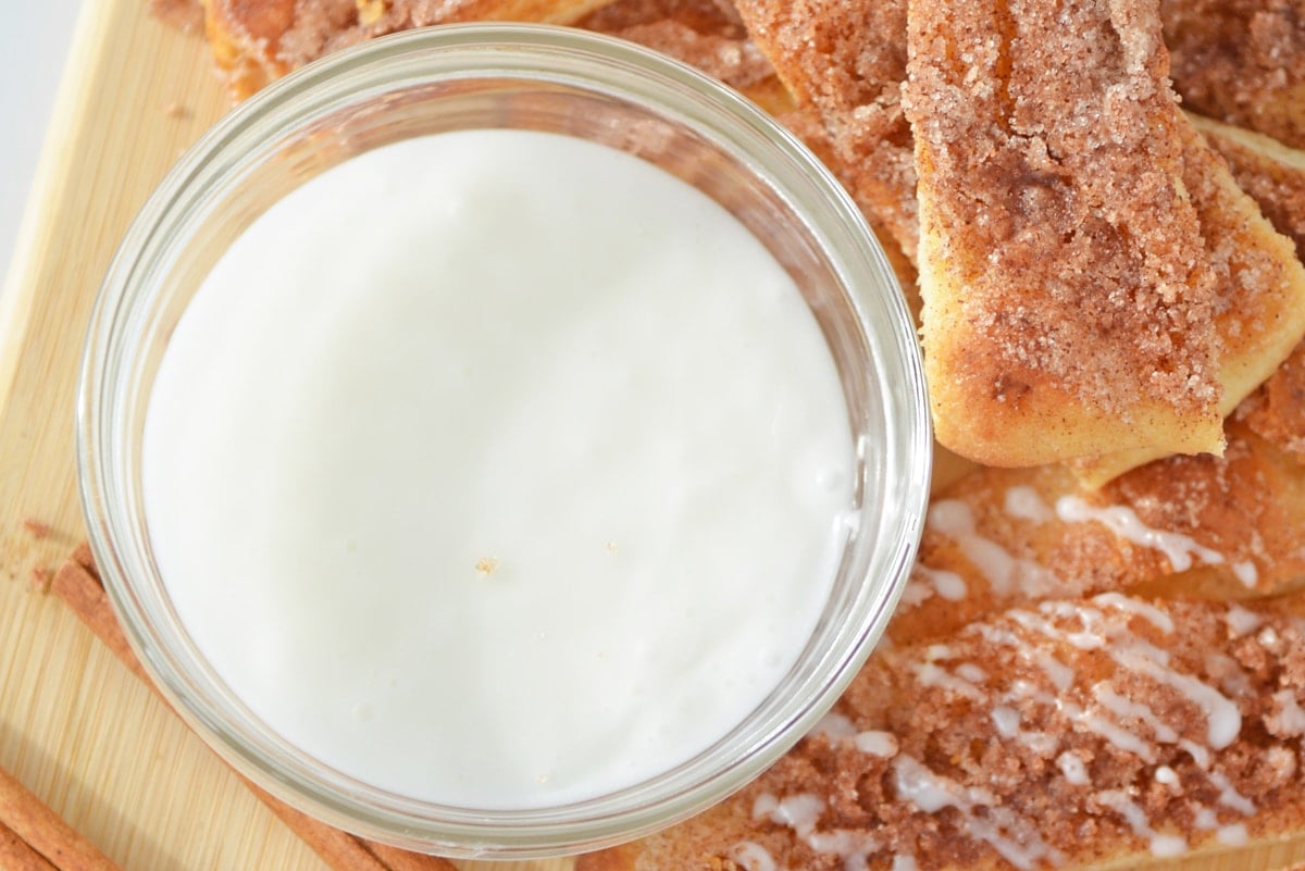 close up of powdered sugar icing in small bowl  
