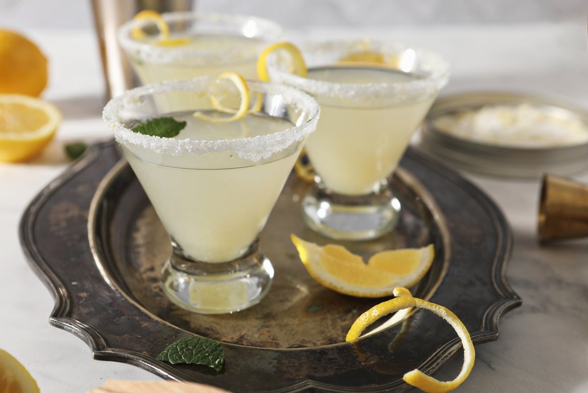 lemon martinis on a tray with lemon garnish 